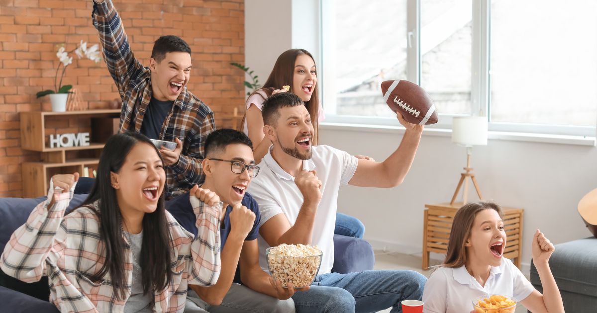 A group of people watching the game and cheering