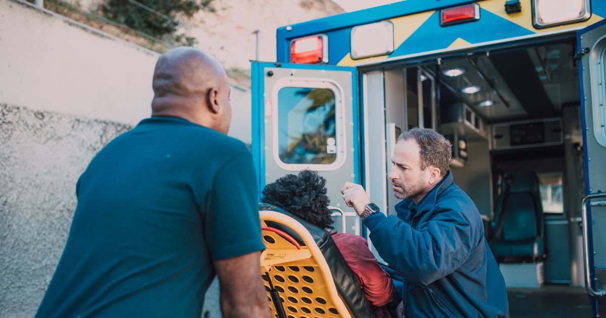 Person put into ambulance by two healthcare workers