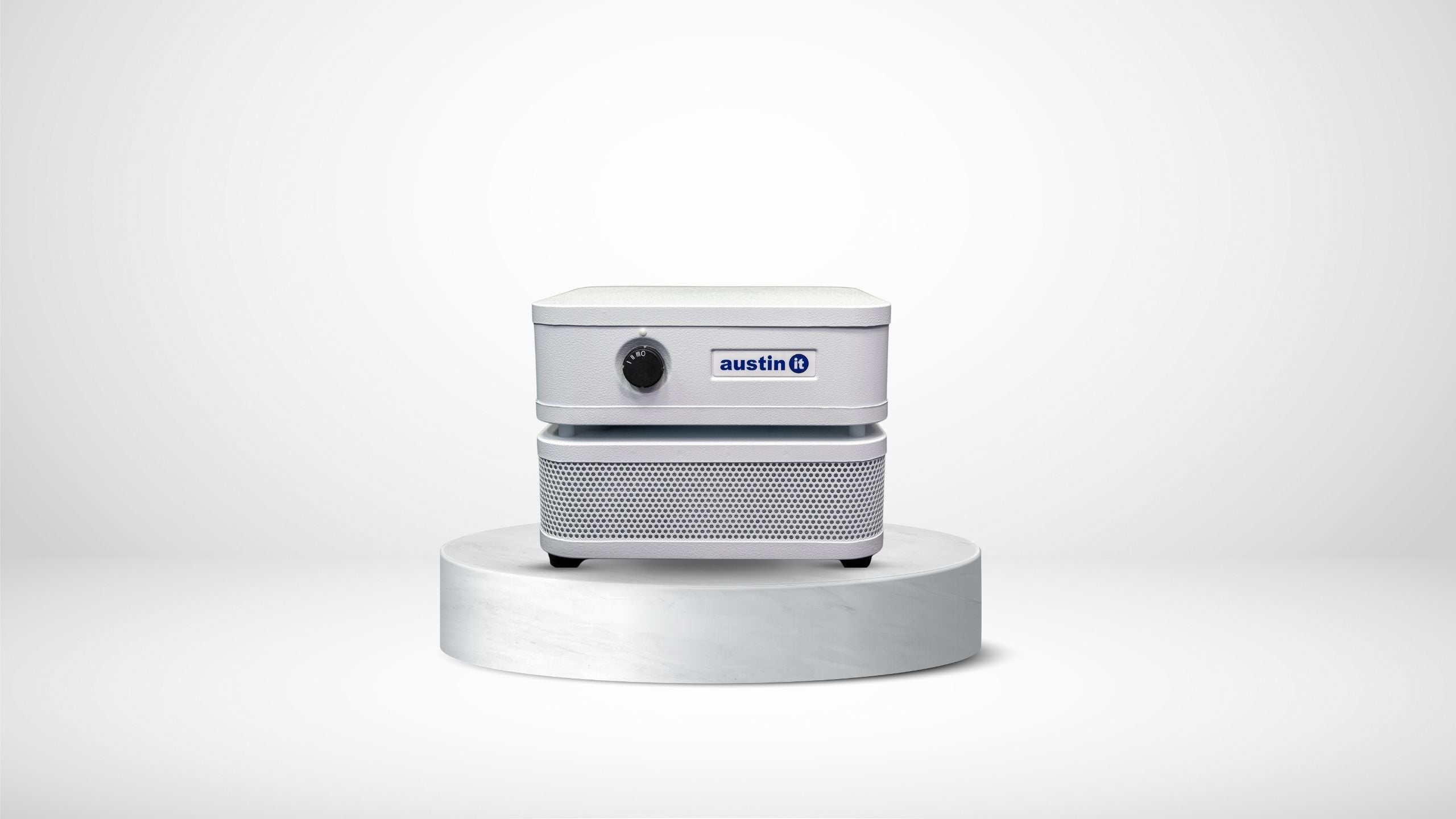 Austin Air IT personal air purifier on top of a round pedestal against a clean white backgrounda 