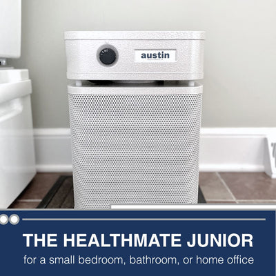 White air purifier labeled 'austin' in a bathroom setting with text about its use.
