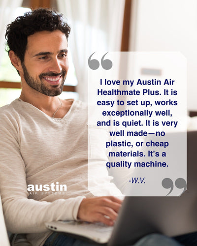 Man using a laptop with a testimonial about the Austin Air Healthmate Plus on a white background
