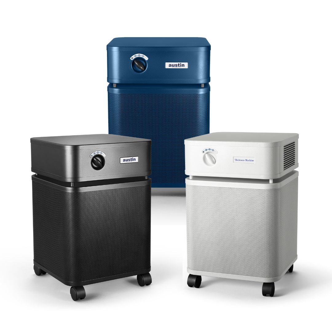 Three air purifiers in black, blue, and silver on a white background
