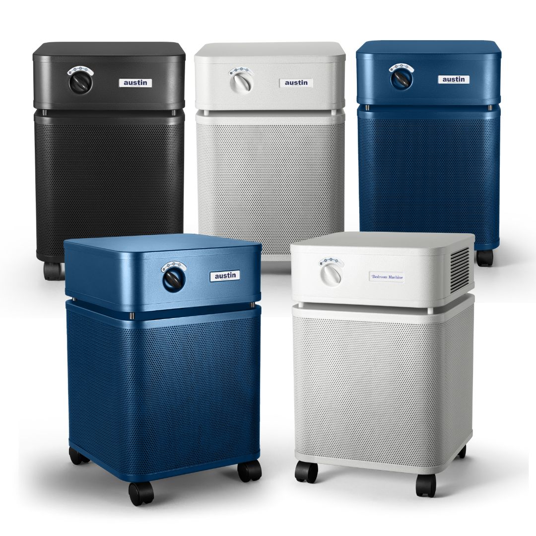 Five Austin air purifiers in black, white, blue, and gray on a white background
