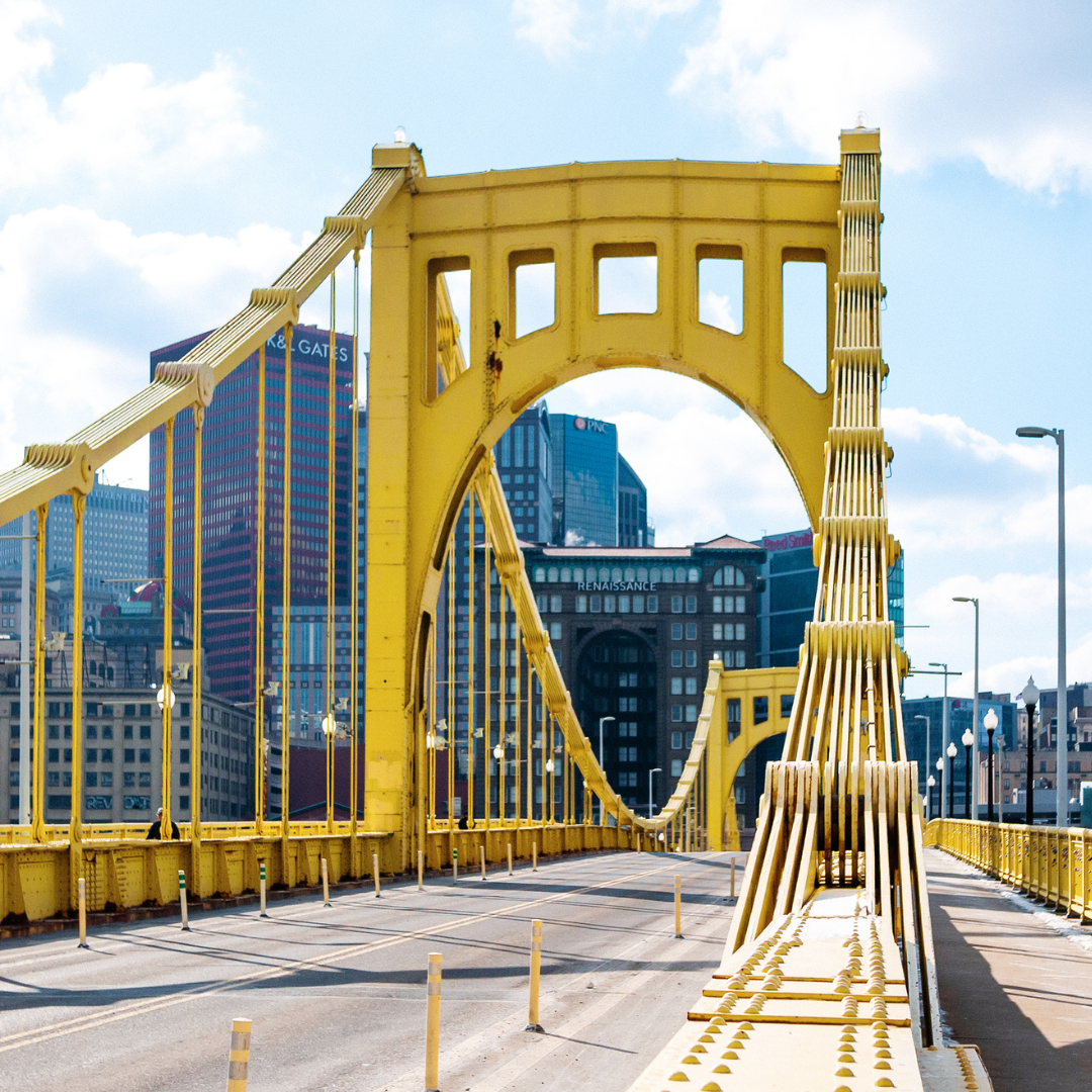 Yellow bridge with pittsburgh city skyline in the background